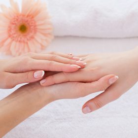 Hands care. Close-up of massage therapist massaging hands of female customer